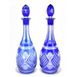 A pair of Bohemian blue flash cut glass decanters and stoppers, height 37cm.Additional