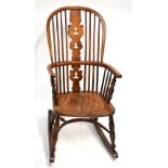 A mid-19th century ash and elm high hoop back Windsor elbow chair with crinoline stretcher and