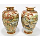 A pair of Japanese Meiji period Satsuma vases, each decorated with geishas and male figures within