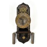 A reproduction brass lantern clock, raised on oak bracket, complete with pendulum and weight, height