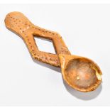 A carved ivory circumcision spoon with incised dot decoration to be used by the Bwami, length 14cm.