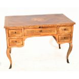 A 19th century Italian parquetry inlaid walnut and burr walnut desk, the quarter veneered top with