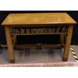 An oak Gothic inspired centre table, the rounded rectangular top above frieze inscribed 'This Do