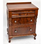 A small mahogany chest with cushion moulded top drawer above two further drawers raised on squat