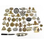 A collection of forty military cap badges and badges to include the Suffolk Regiment, The Lancashire