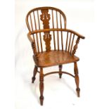 A mid-19th century ash and elm low hoop back elbow chair with crinoline stretcher and turned front