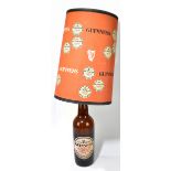 GUINNESS; a large glass advertising bottle lamp, with Guinness label and original shade, overall