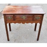 A George III oak lowboy, with three drawers, on straight legs, height 75cm, width 83cm, depth