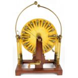 WIMSHURST MACHINE; with elaborate brass frame and brass mounted mahogany base, height 67cm.