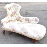 A late Victorian chaise longue of small proportions upholstered in a contemporary floral fabric