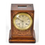 A 19th century rosewood cased mantel clock with inlaid decoration, the circular silvered dial with