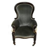 A Victorian mahogany spoon back armchair with serpentine seat and turned supports.