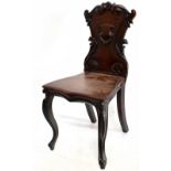 A Victorian carved mahogany hall chair, height 87cm. Additional InformationOld dowel repair to the