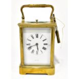 A late 19th century French brass repeating carriage clock, the enamelled dial with Roman numerals,