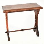 A late Victorian Gothic inspired oak side table raised on pierced shaped end supports united by a