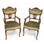 A pair of Edwardian mahogany salon elbow chairs with padded stuff-over seats and cabriole front