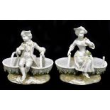 JOHANSEN ROFF; a pair of late 19th century German porcelain table salts, each modelled as seated