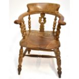 A Victorian elm seated smoker's bow back elbow chair.