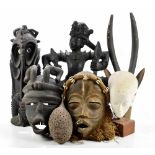 A small group of tribal art including African masks, also an Eastern darkwood carving, etc.