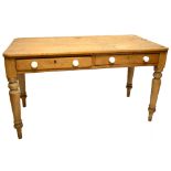 A pine two drawer kitchen table with rectangular top raised on turned supports, length approx.