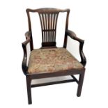 A George III mahogany elbow chair with shaped top rail above pierced splat back, swept arms,