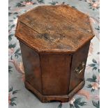 A 19th century octagonal oak cellarette/coal bin, the hinged lid enclosing a metal liner with twin