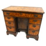 A good early 20th century Georgian style walnut kneehole desk, the cross and herringbone banded