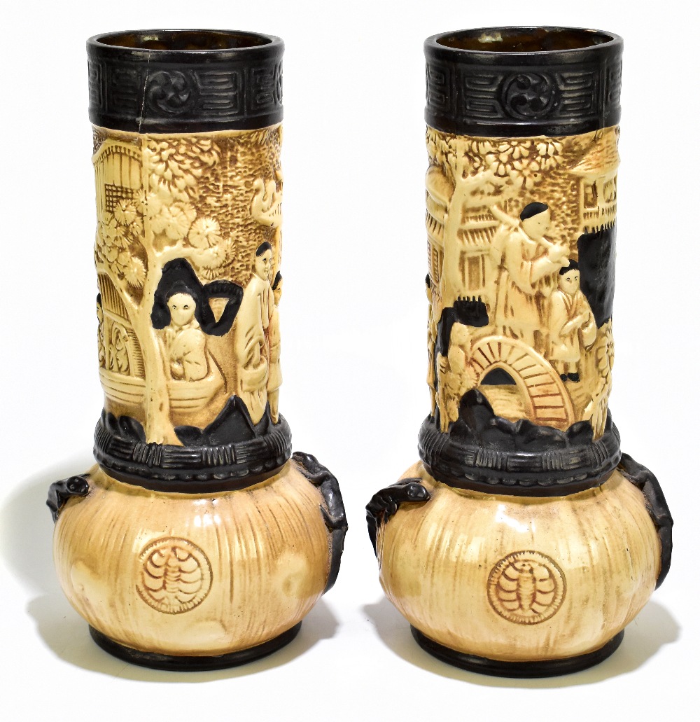 BRETBY; a pair of Oriental inspired relief decorated vases, height 37cm (one af).Additional