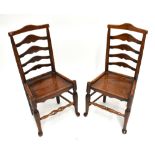 A harlequin set of eight 19th century Lancashire ladder back chairs, with shaped top rail and