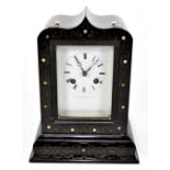 A Victorian ebonised mantel clock, the case with inlaid pewter and mother of pearl detail, the