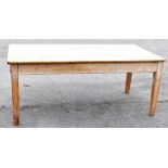A pine rectangular kitchen table raised on tapering square section legs, length 180cm. PROVENANCE: