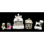 STAFFORDSHIRE; three 19th century models of poodles including an example raised on a cushion, height