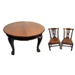 A late Victorian mahogany extending dining table with two extra leaves on cabriole legs to claw