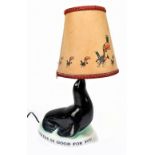 GUINNESS; an advertising Carltonware seal lamp with associated shade, overall height 33cm.Additional