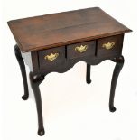 An 18th century oak lowboy, the two piece plank rectangular top above three drawers and raised on