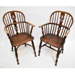 A near pair of mid to late 19th century ash and elm low hoop back Windsor elbow chairs, one with