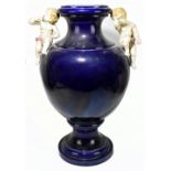 PARIS 1878; a very large blue glazed majolica twin handled vase set with cherubs beside the flared