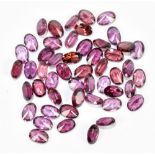 RHODOLITE; fifty 6 x 4mm oval cut stones.