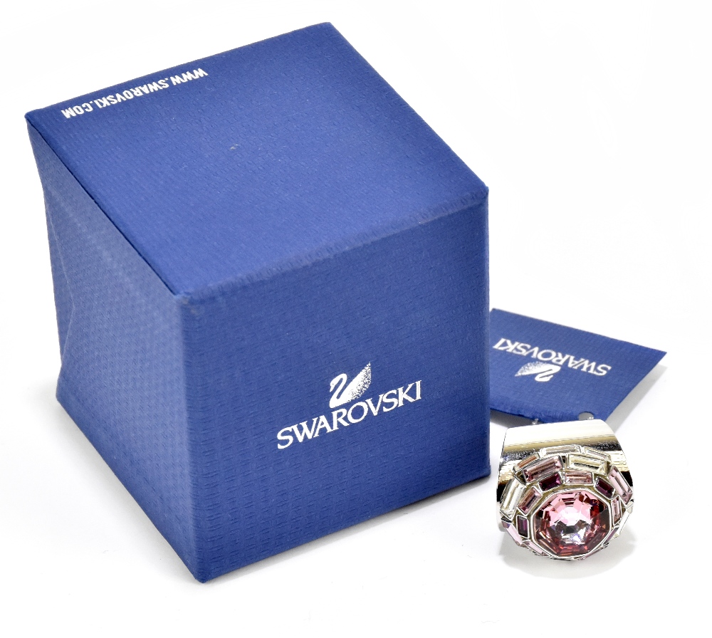 SWAROVSKI; a LMUL/PDS silver tone dress ring with a large rose pink crystal solitaire surrounded