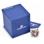 SWAROVSKI; a LMUL/PDS silver tone dress ring with a large rose pink crystal solitaire surrounded