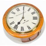 A late Victorian light oak circular wall clock, the painted dial set with Roman numerals