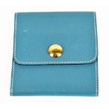 HERMÈS; a calfskin blue pebbled leather post-it note case with gold tone embossed pop stud to