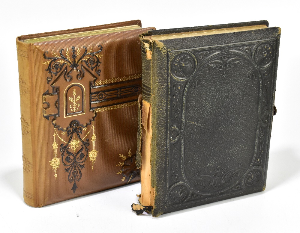 Two Victorian photograph albums including a brown leatherette example with gilt floral tooling,