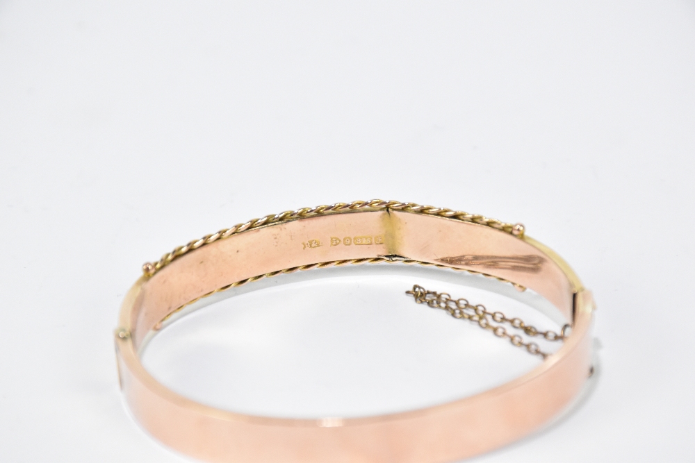 A 9ct yellow gold hinged snap bangle set with two small sapphire and three diamond chips to the - Image 2 of 2