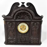 A 19th century carved oak mantel clock, with Macclesfield carved detail inscribed 'My time is in thy