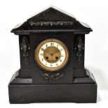 A Victorian slate mantel clock with applied gilt metal detail surrounding a circular dial set with
