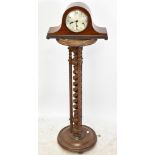 An early 20th century mahogany mantel clock, the silvered dial set with Arabic numerals, with carved