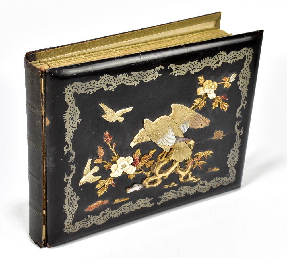 An early 20th century Japanese photograph album with lacquered panels to the front and back, the