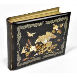 An early 20th century Japanese photograph album with lacquered panels to the front and back, the