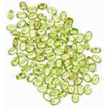 PERIDOT; one hundred faceted oval cut 6 x 4mm stones.